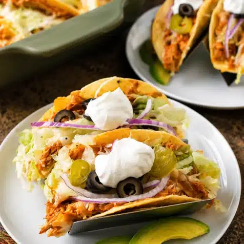 Easy Rotisserie Chicken Tacos topped with sour cream, olives, and avocado