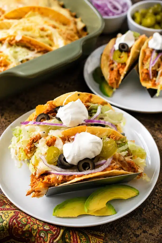 Easy Rotisserie Chicken Tacos topped with sour cream, olives, and avocado