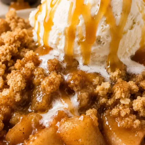 Old fashioned apple crisp with vanilla ice cream and caramel topping